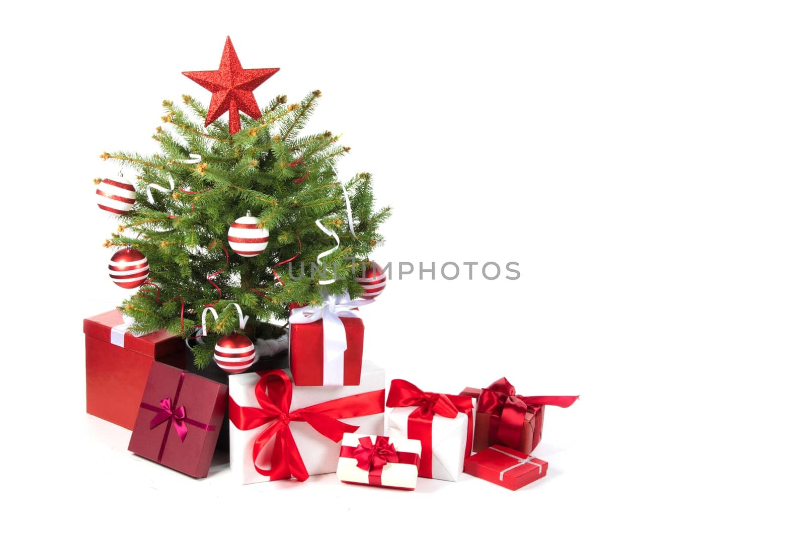 Decorated Christmas tree and gift boxes isolated on white background