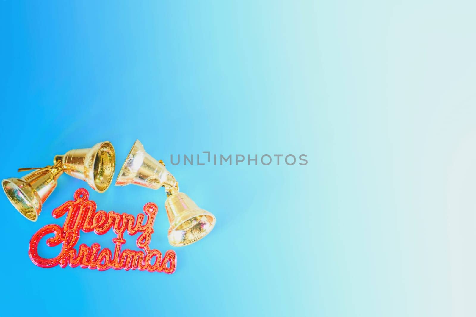 Merry Christmas inscription and golden bells on a blue background by jovani68