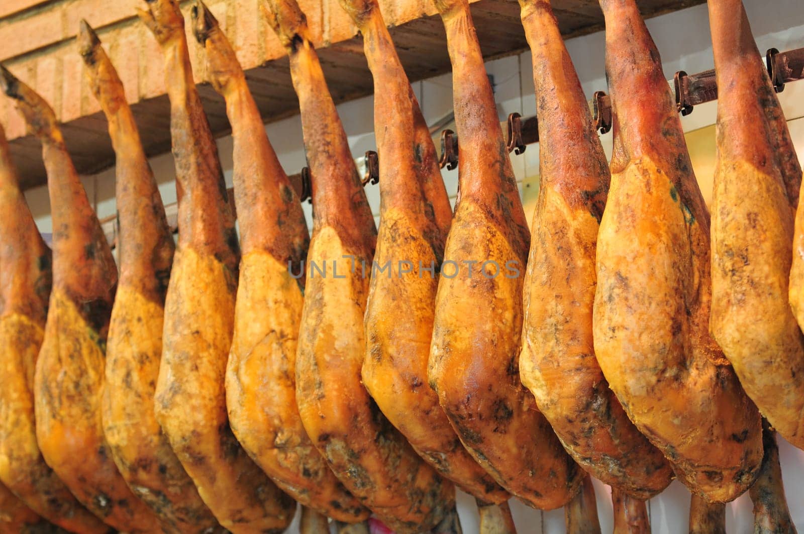 Legs of spanish serrano ham in the market place.