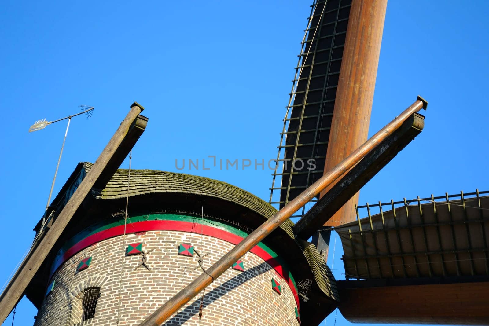 old windmill with tensioned sails
