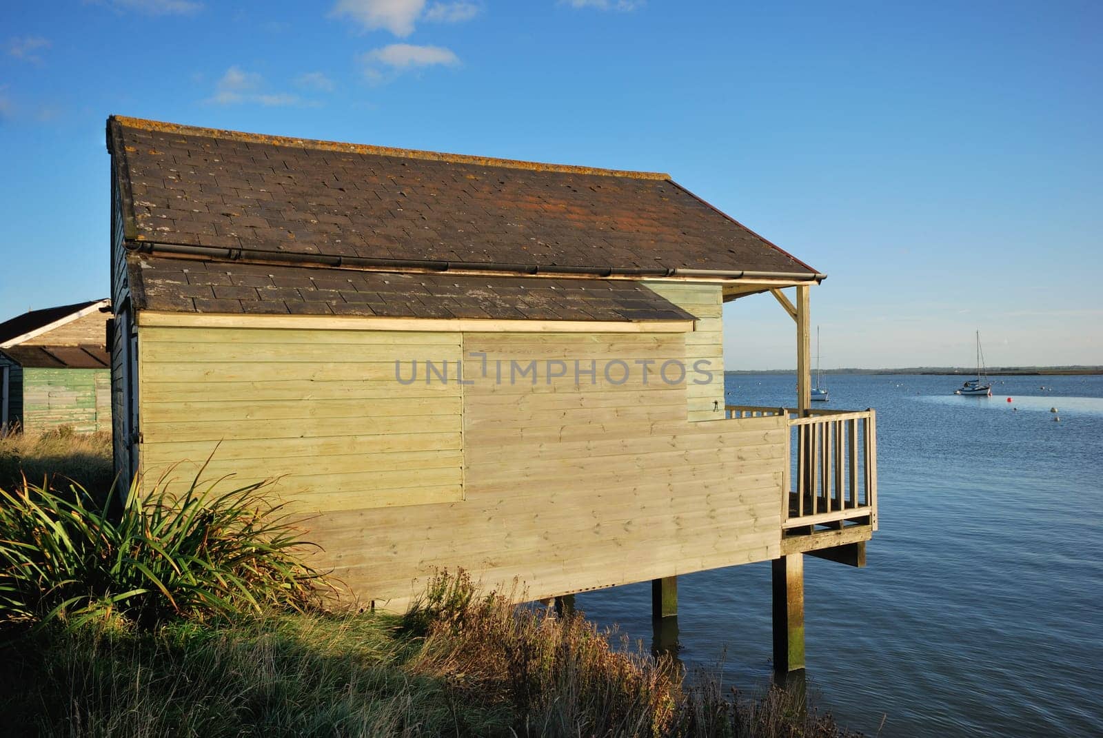 wooden house on side of river
