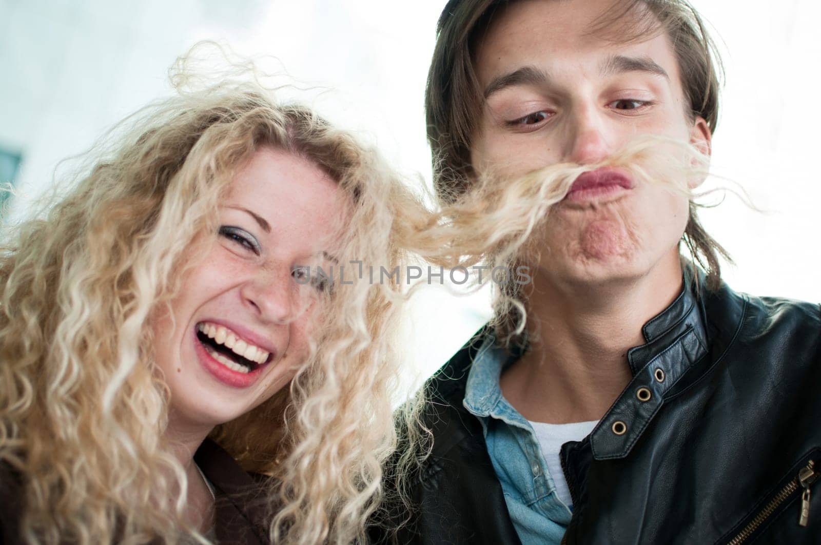 Big fun - couple playing with hair
