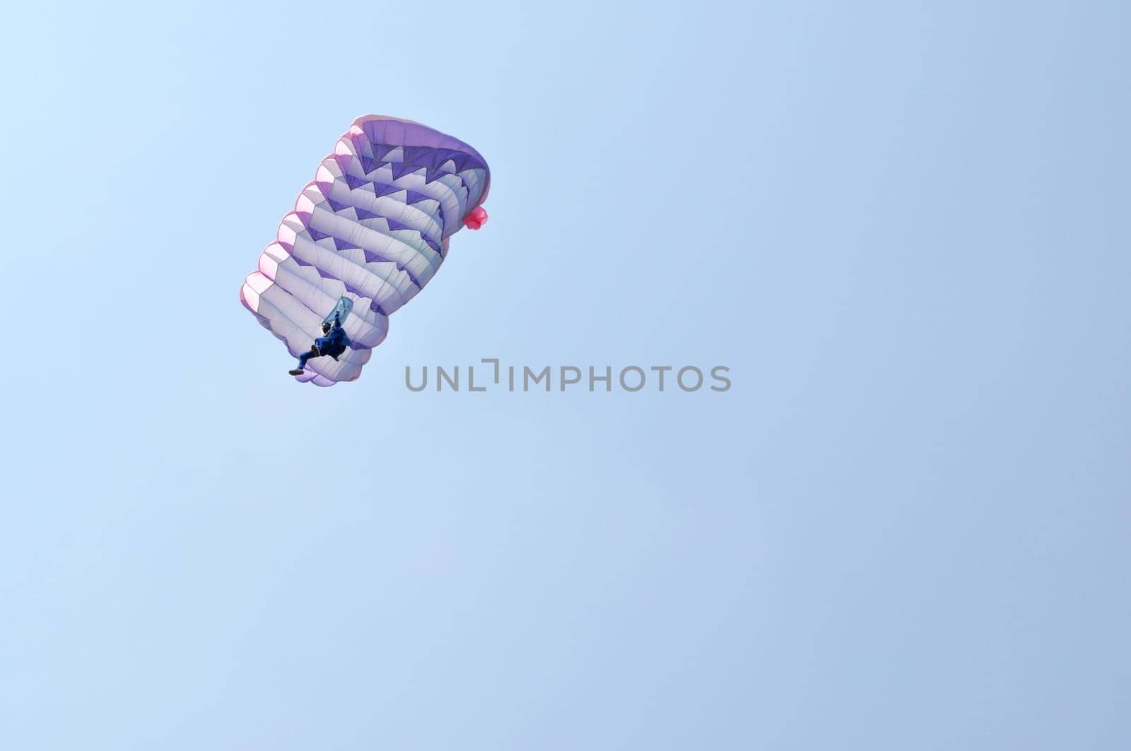 A parachute over a blue sky background
