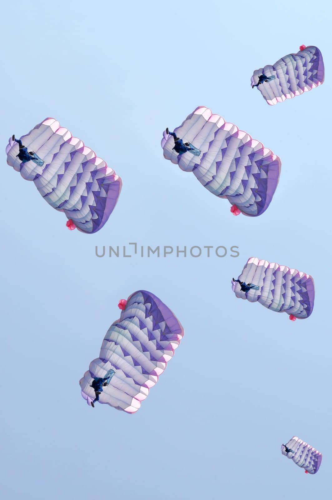 Many parachutes over a blue sky background