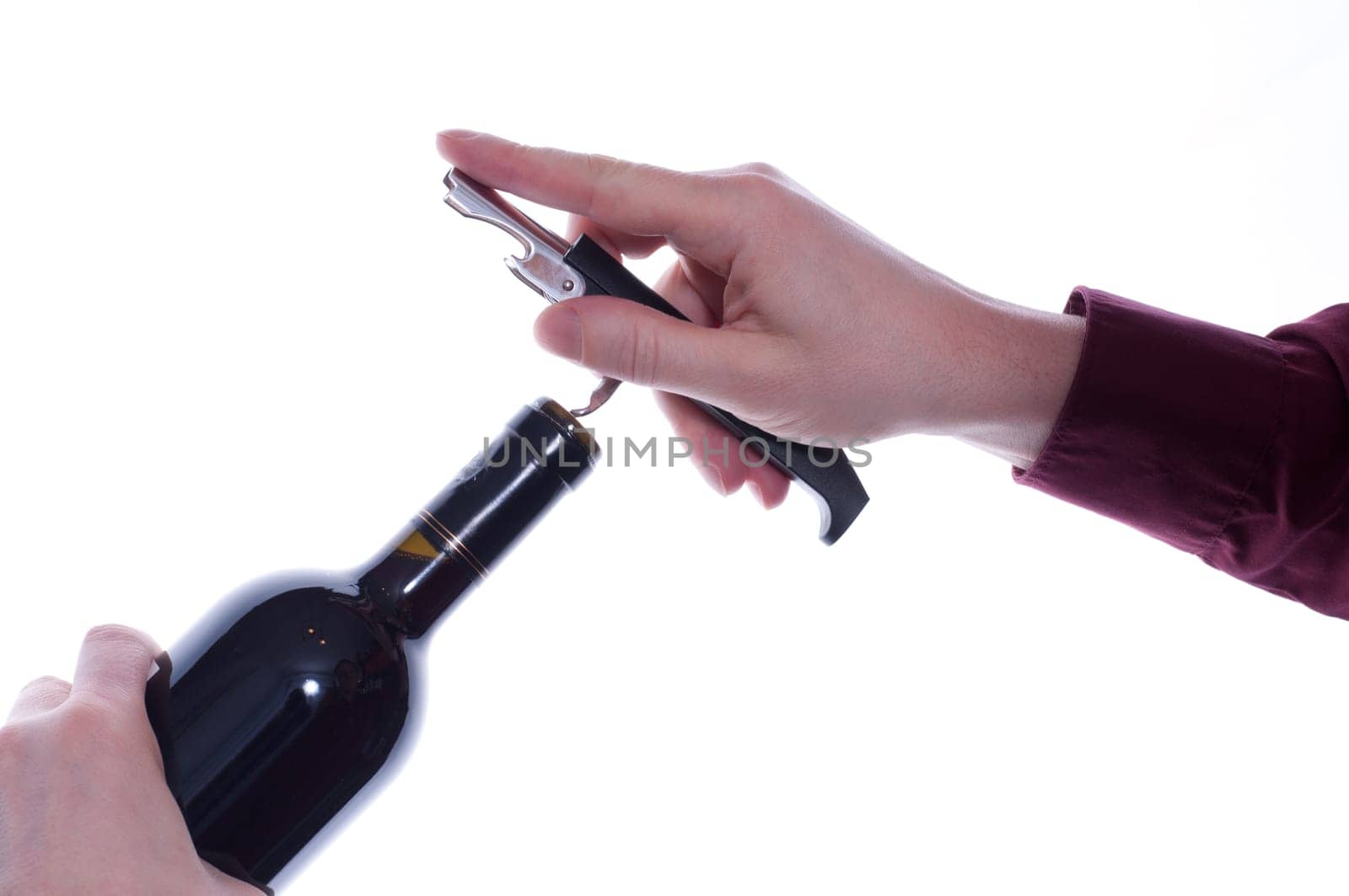 Hand puts a waiter's knife to pull the cork