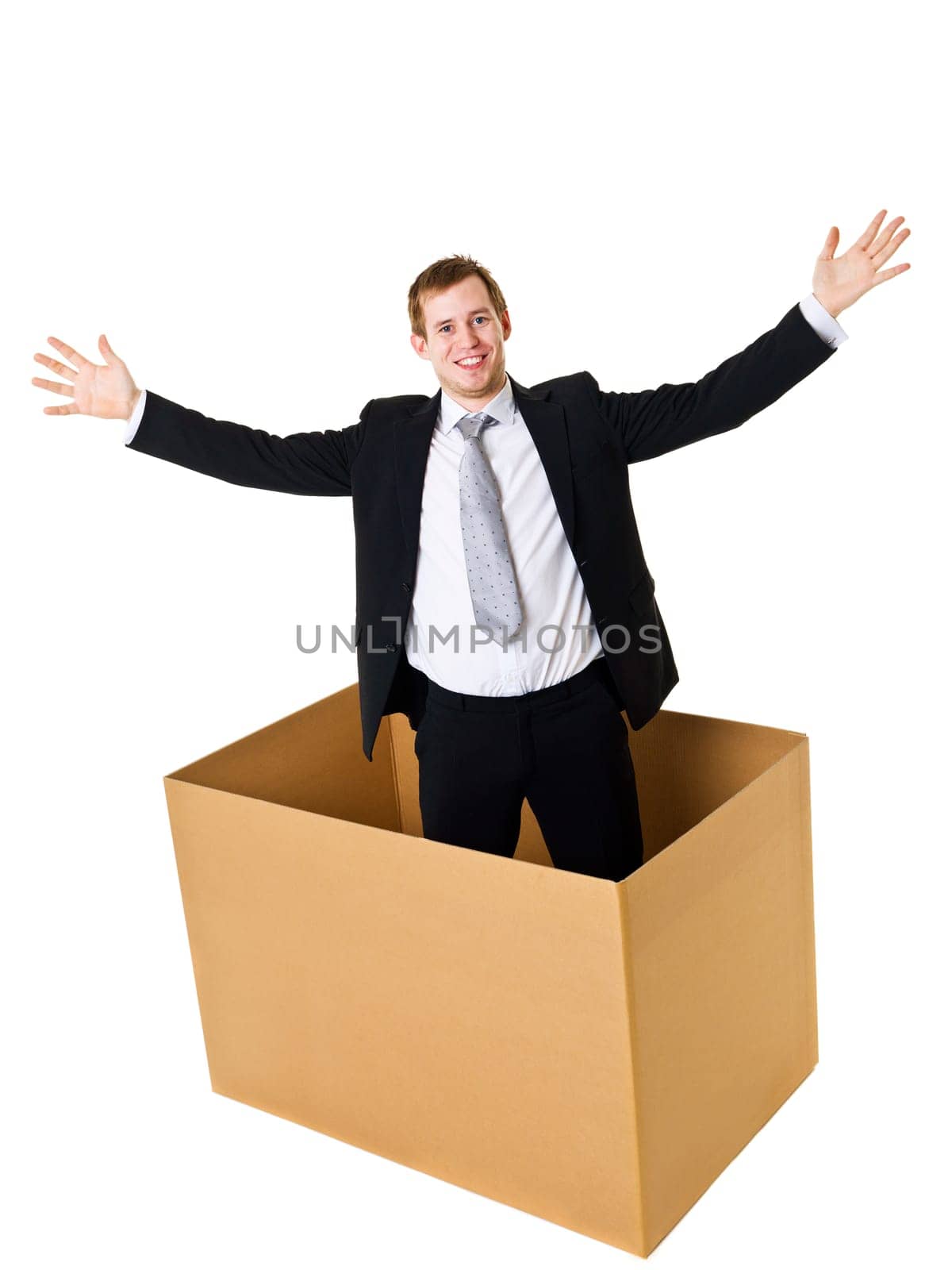 Businessman in a cardboard box isolated on white background