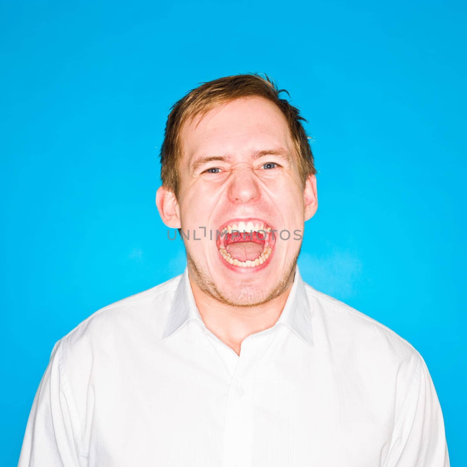 Portrait of a young man on blue background