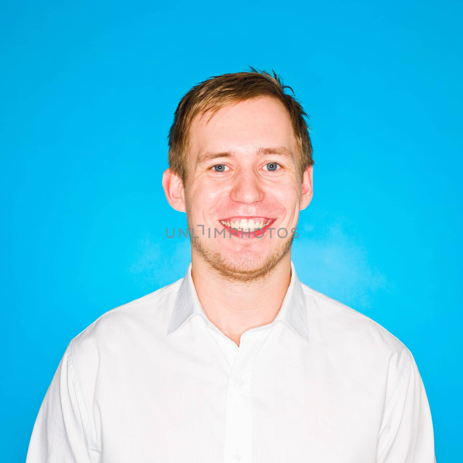 Portrait of a young man on blue background
