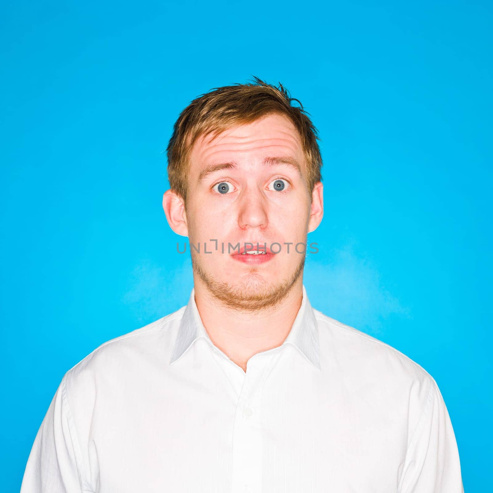 Portrait of a young man on blue background