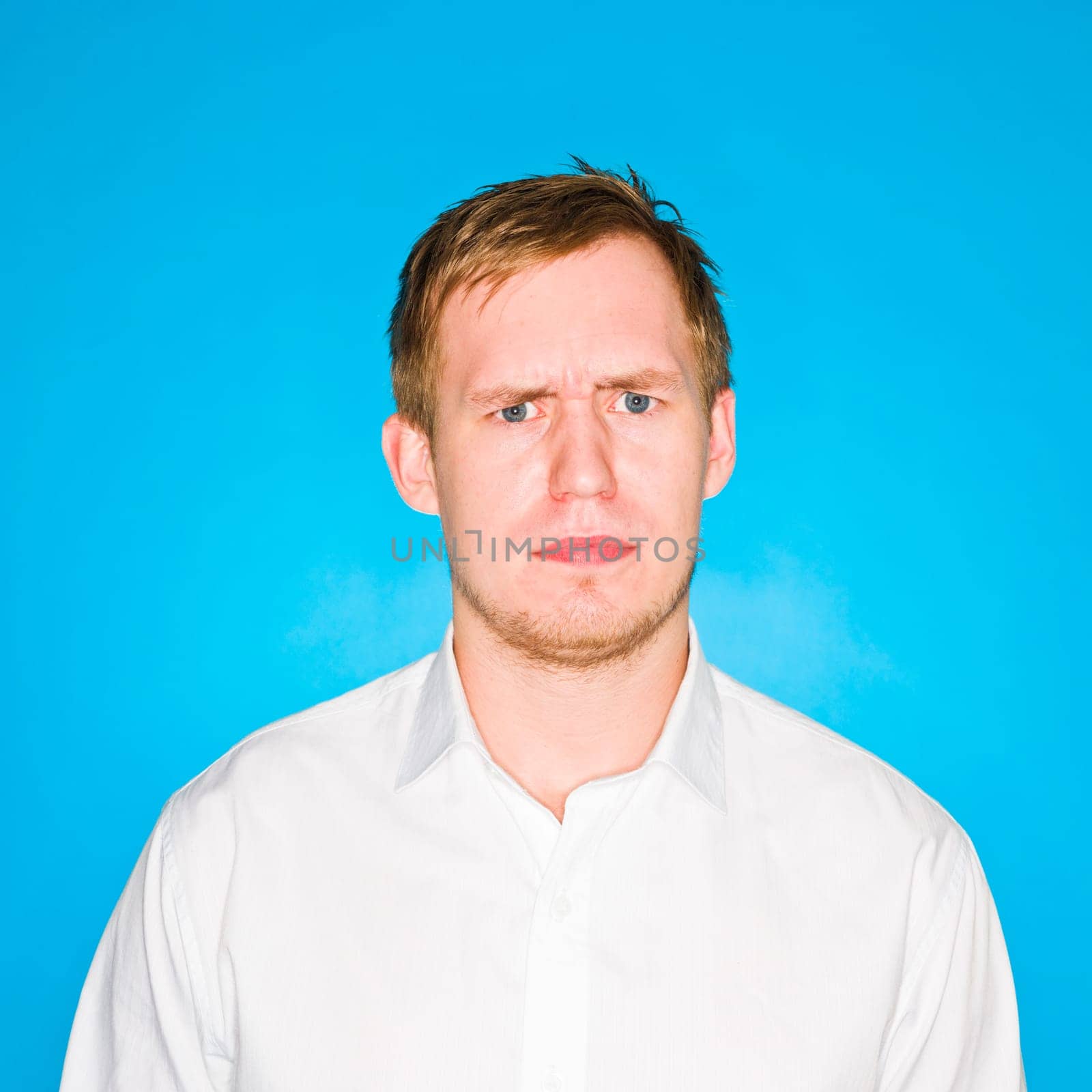 Portrait of a young man on blue background