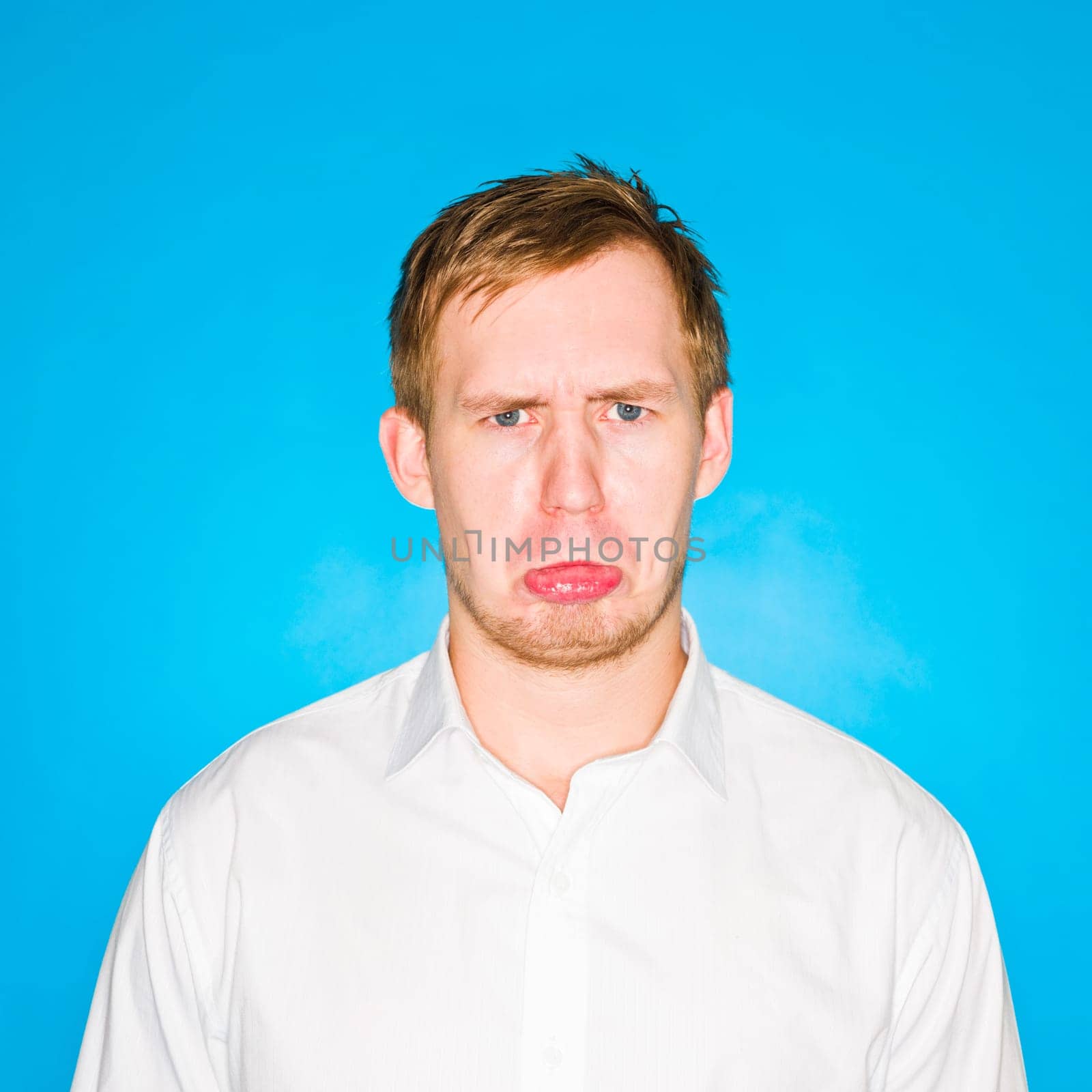 Portrait of a young man on blue background