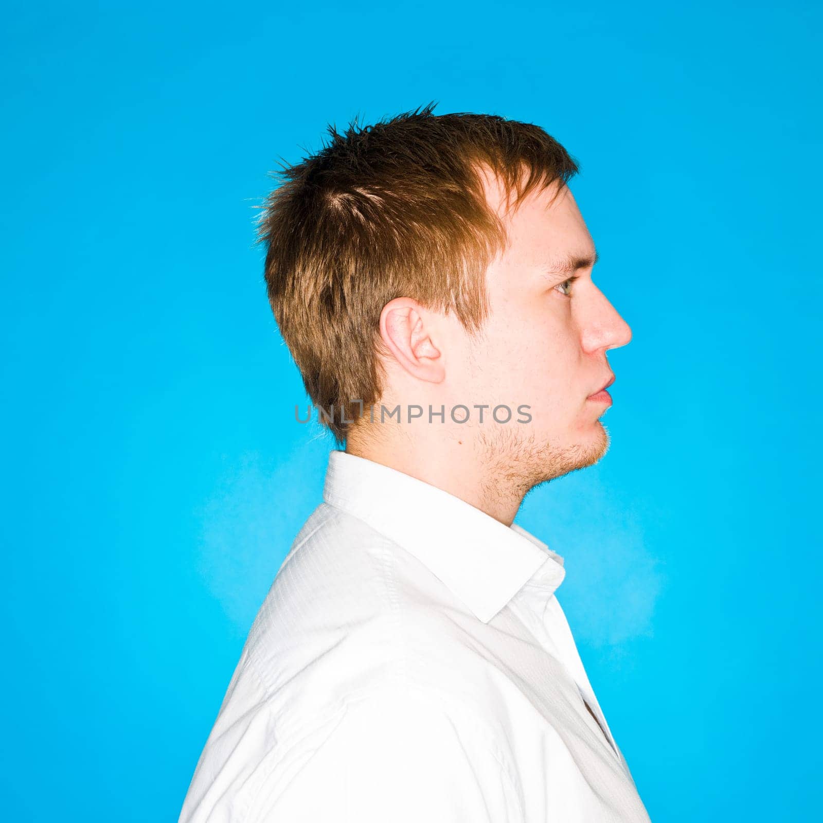Portrait of a young man on blue background