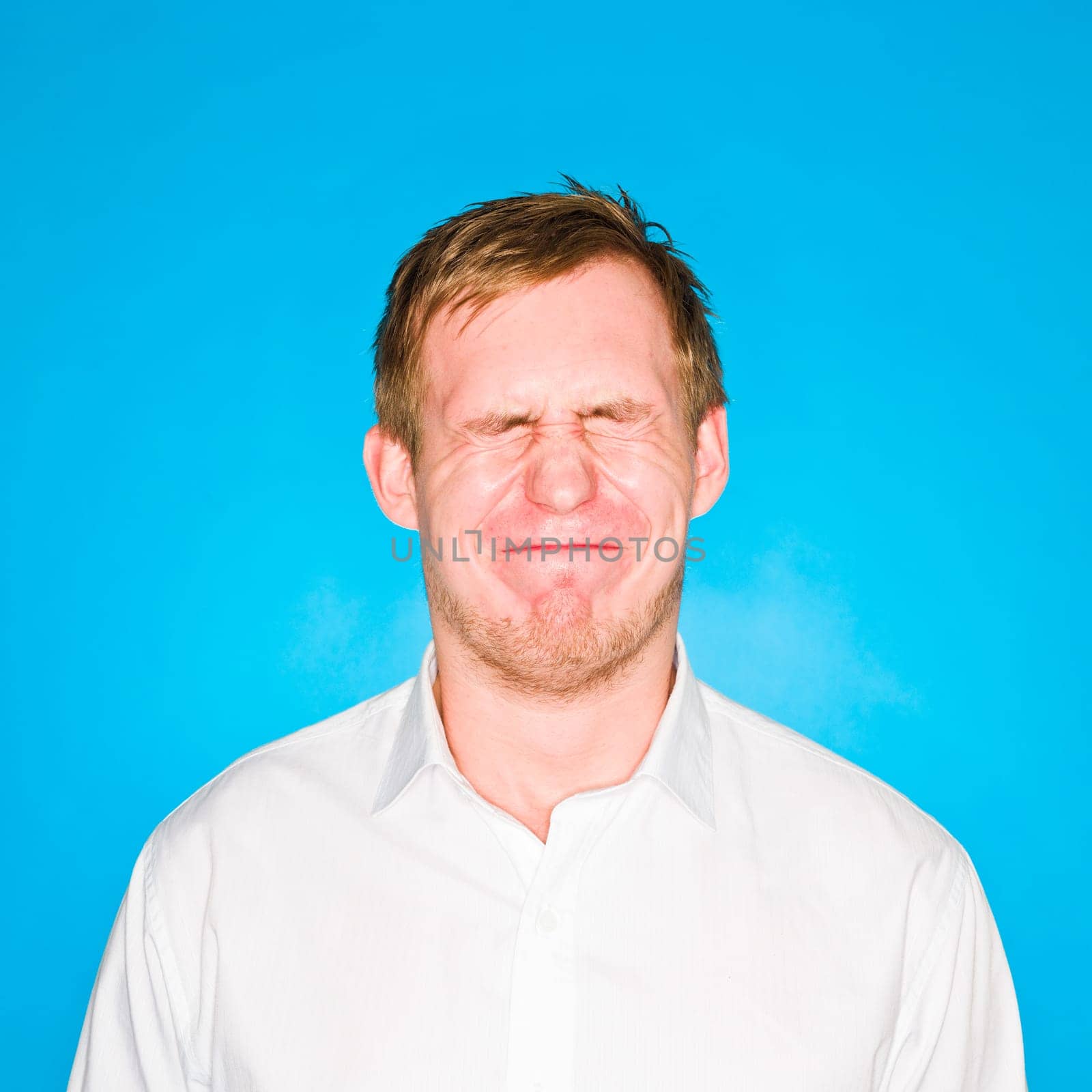 Portrait of a young man on blue background