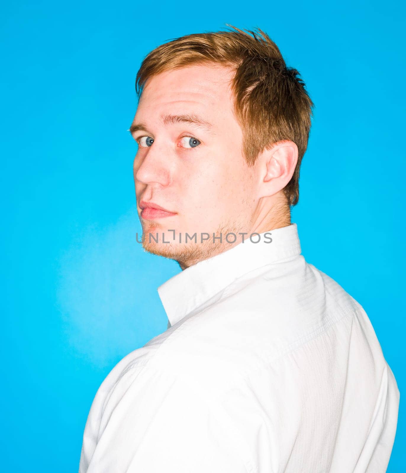 Portrait of a young man on blue background