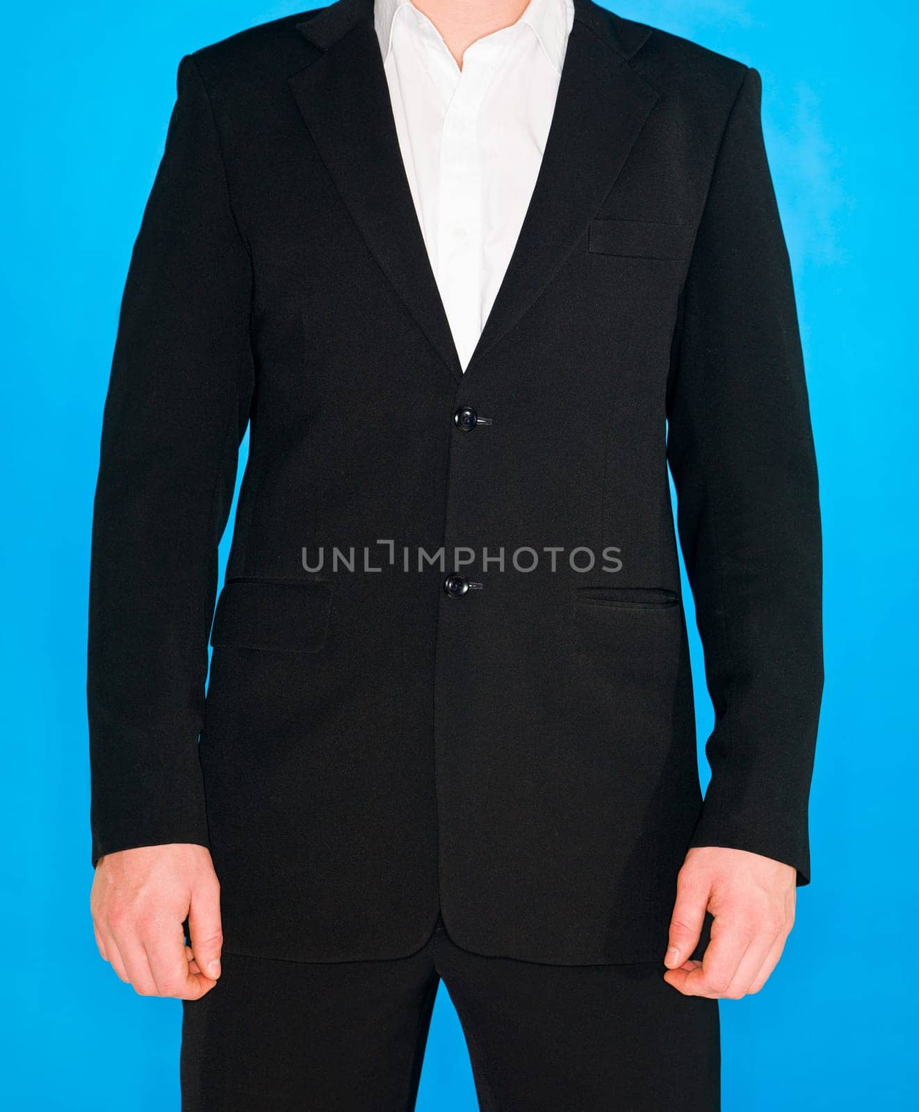 Part of a well dressed man on blue background