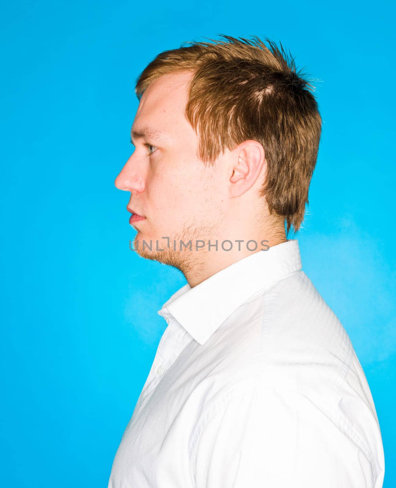 Portrait of a young man on blue background