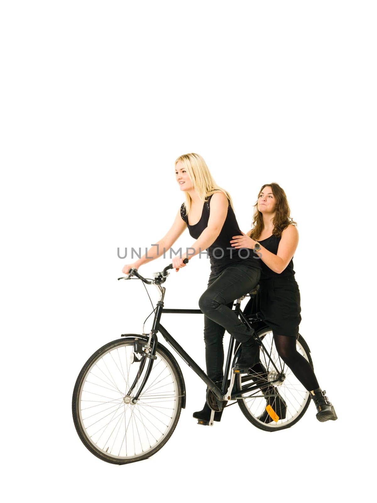 Two women on a bicycle isolated on white background