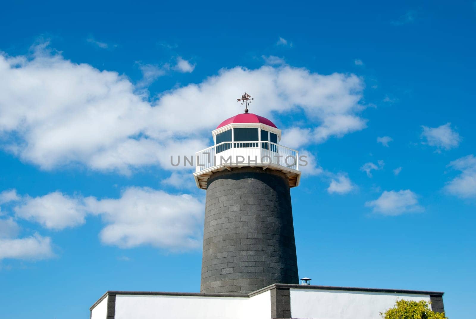 An Old Lighthouse in the Canary Islands with a sailing ship Weathervane