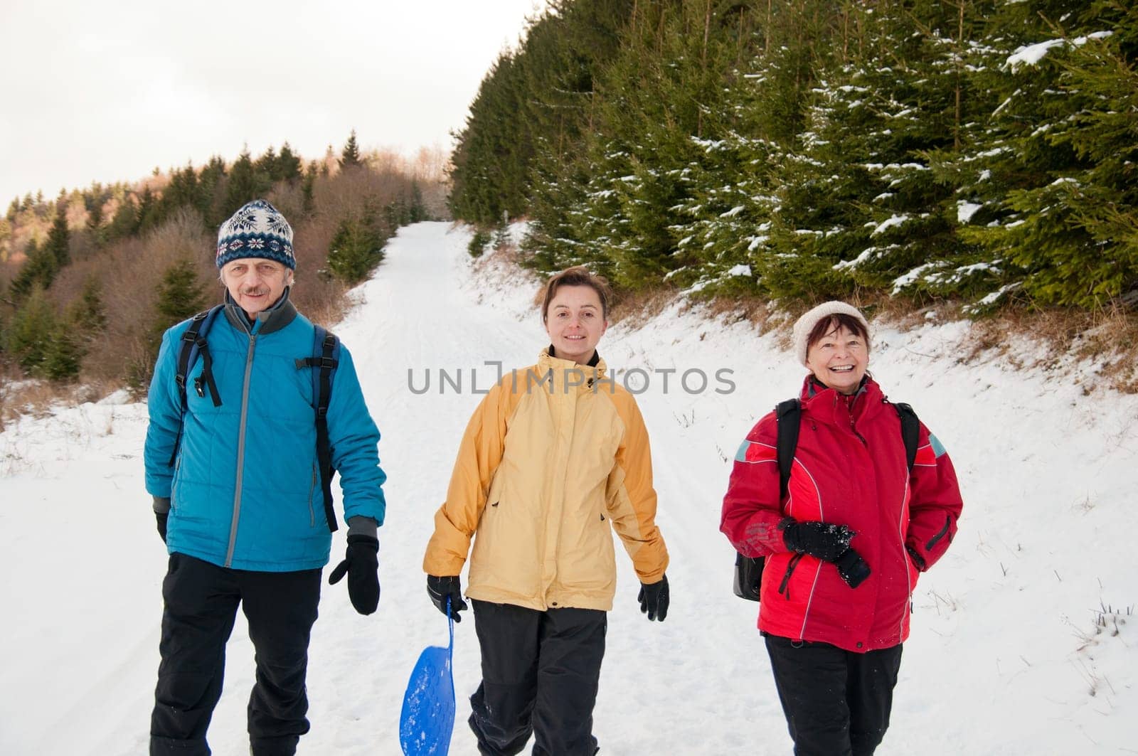 Family in winter together walking in snow