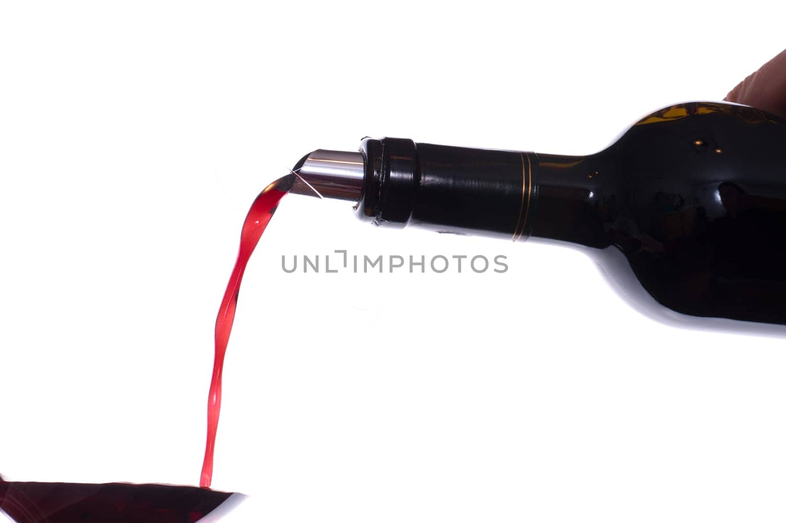 Red wine is poured into a wine glass