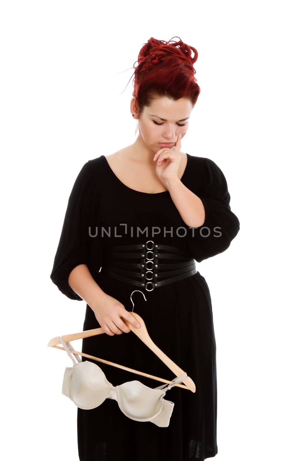 Young modern girl with red hair isolated on a white background, wearing bra.
