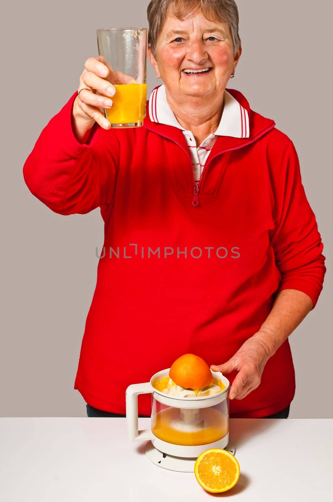 Senior citizen squeezes orange juice