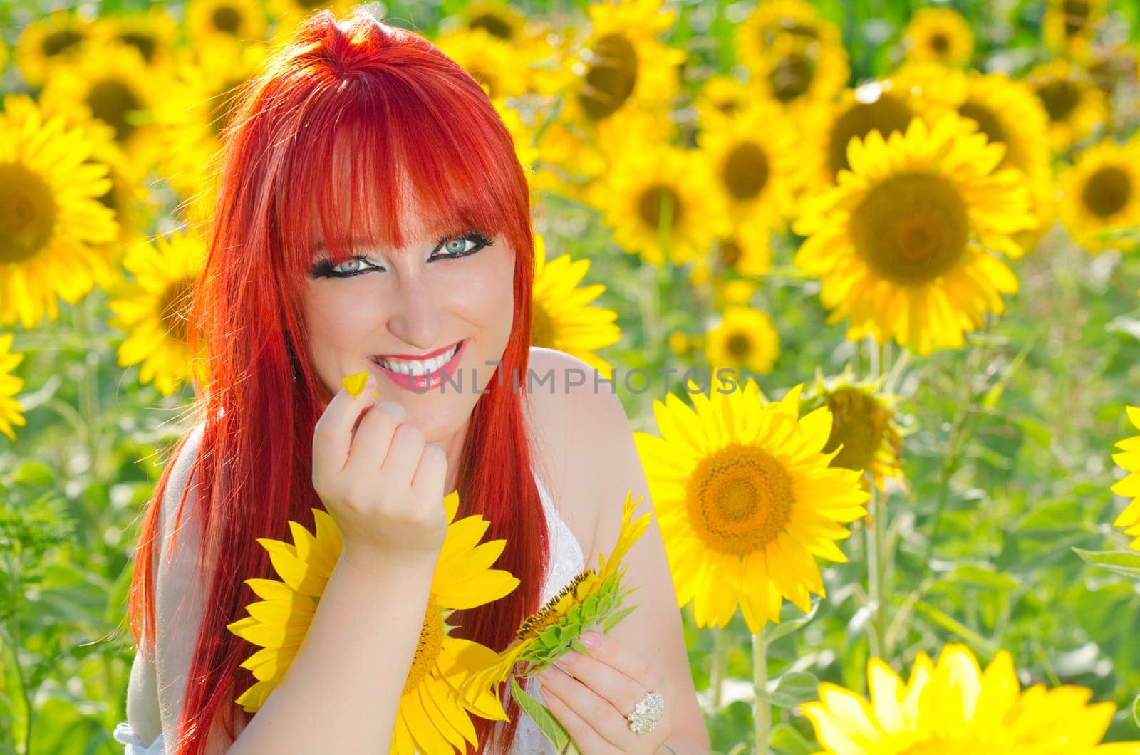 A woman smiling on a sunflower field