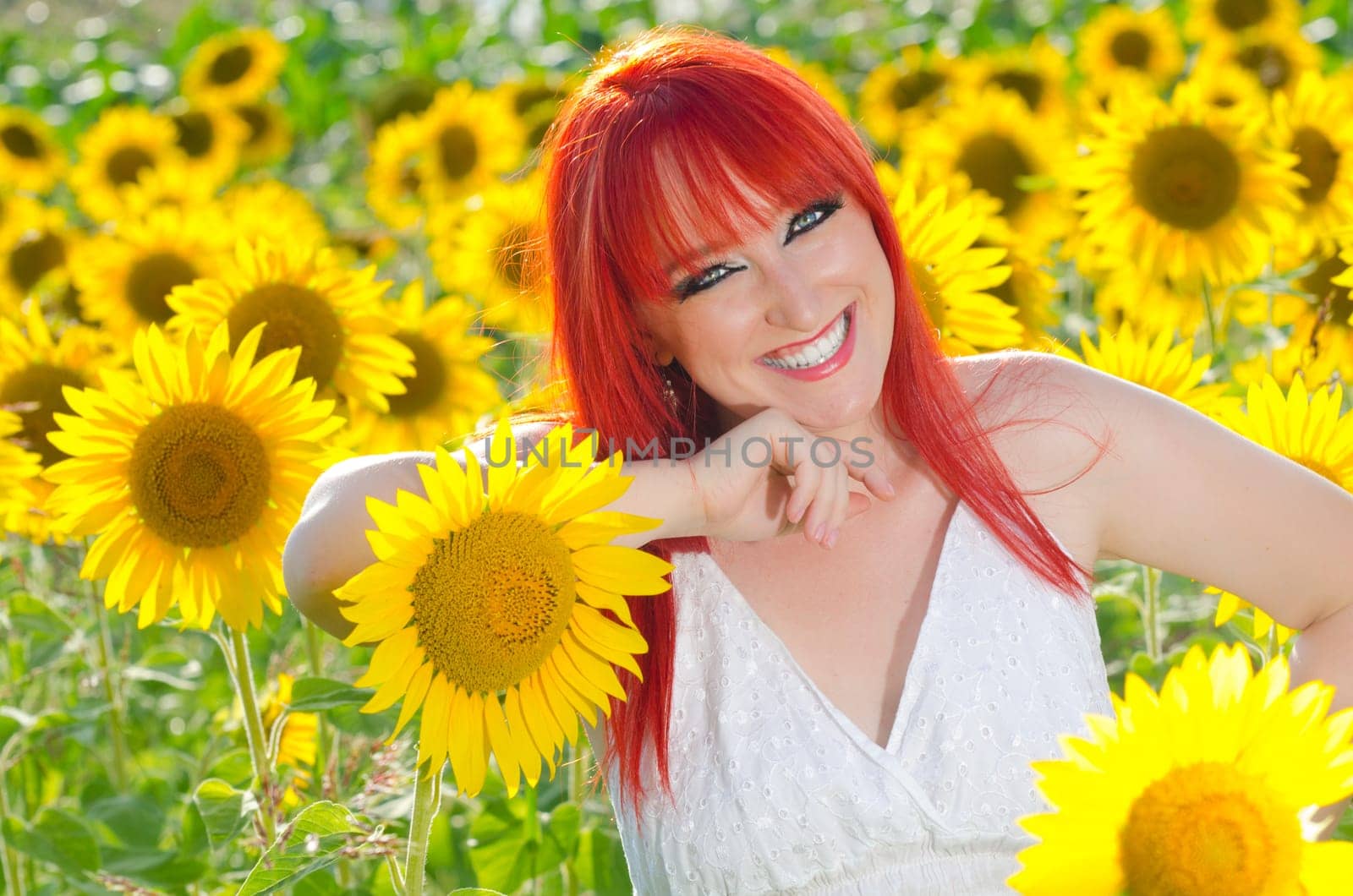 A woman smiling on a sunflower field