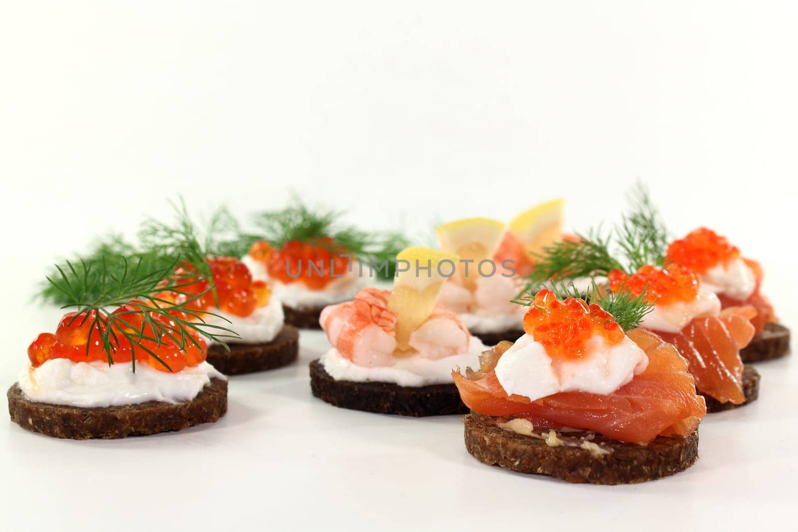 Various canapes against white background