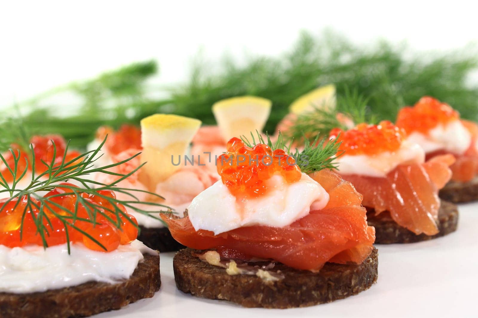 Various canapes against white background