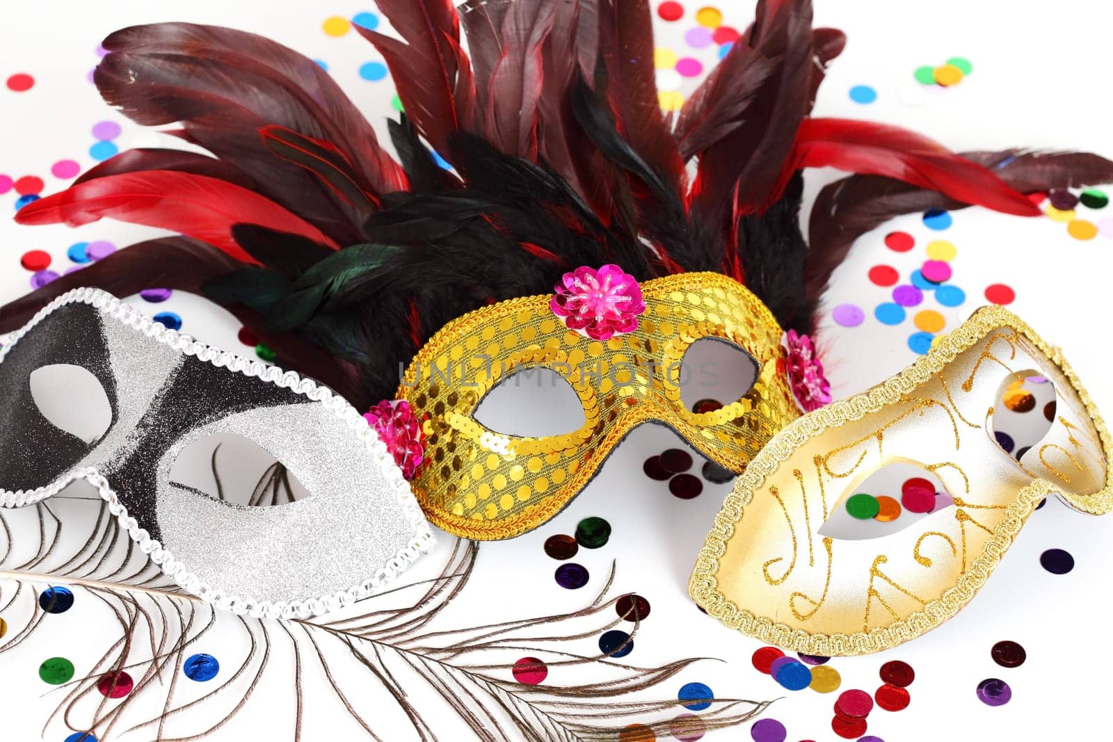 Carnival mask with confetti on white background