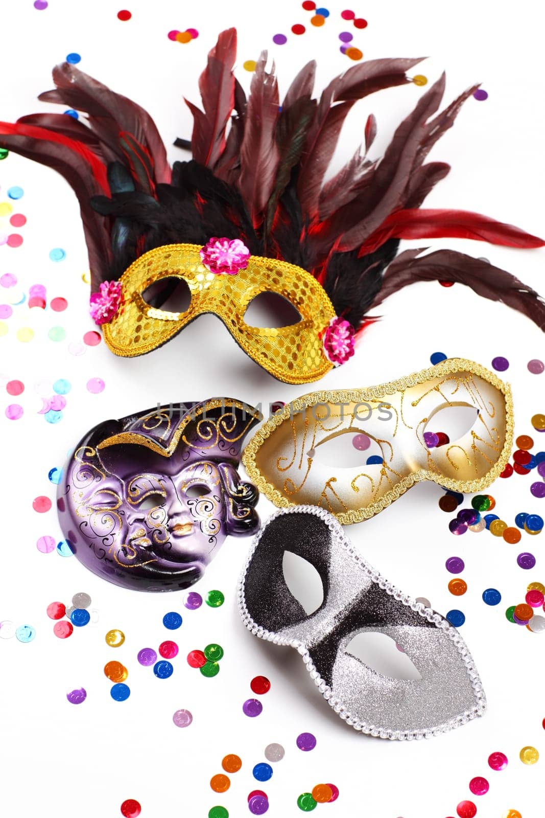 Carnival mask with confetti on white background