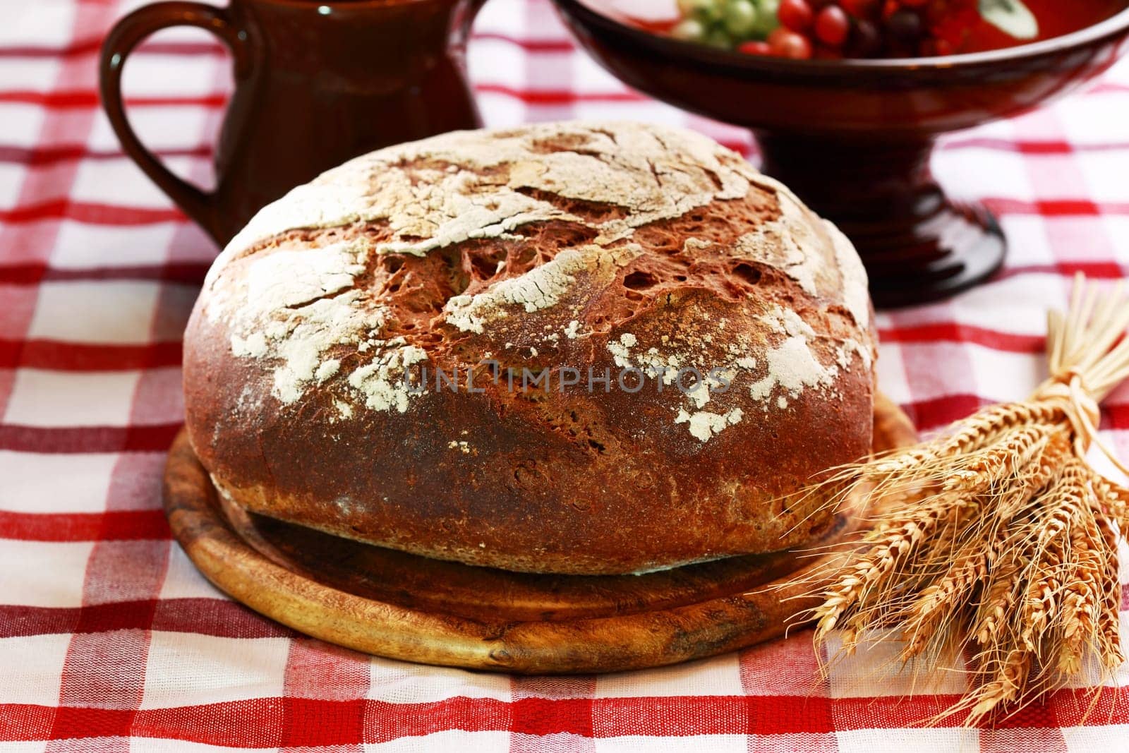 Loaf of rustic bread on black background