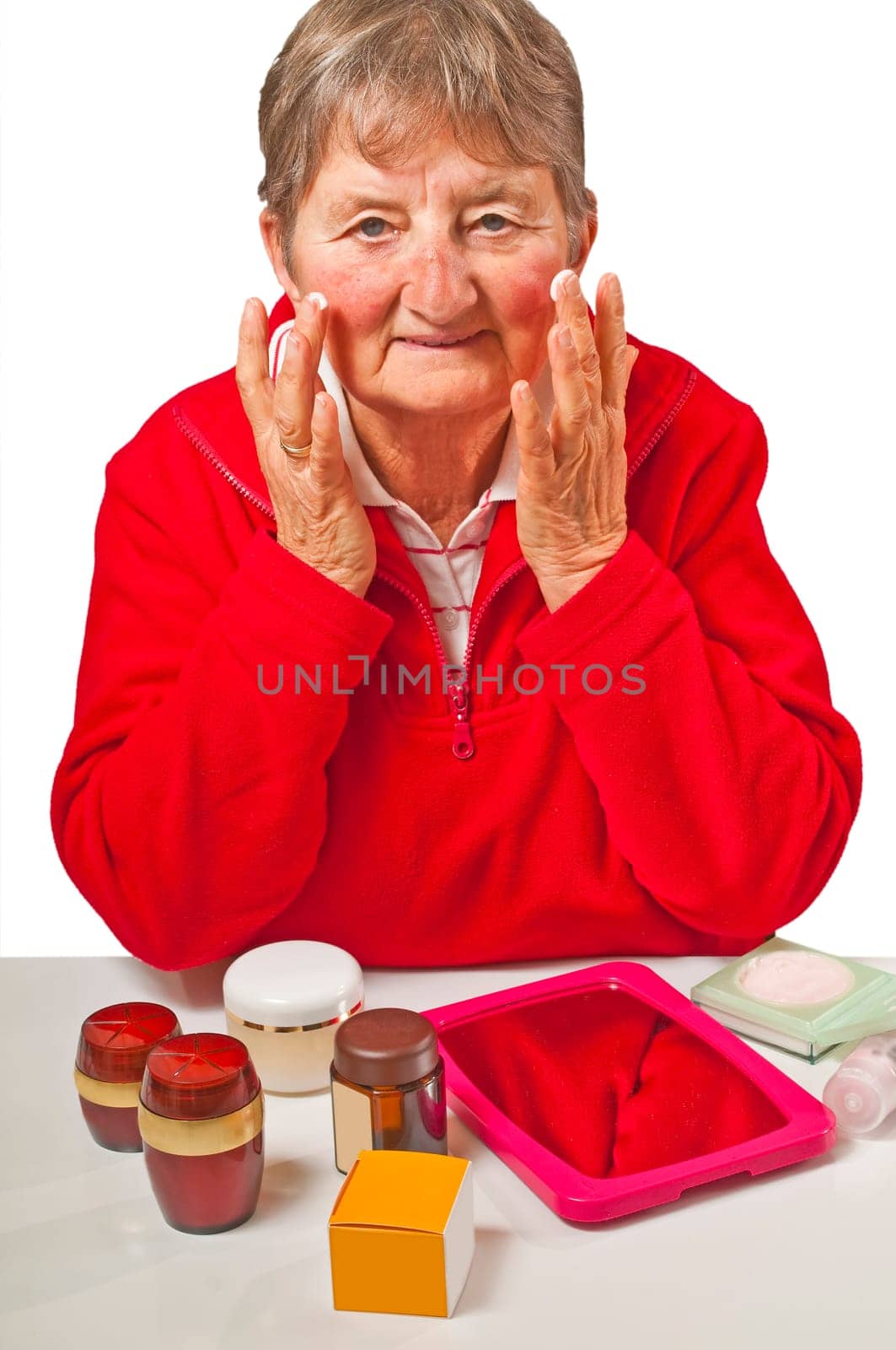 Senior woman with cosmetic products