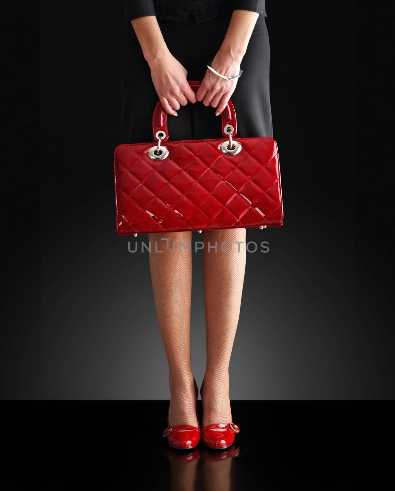 fashionable woman with a red bag, only legs