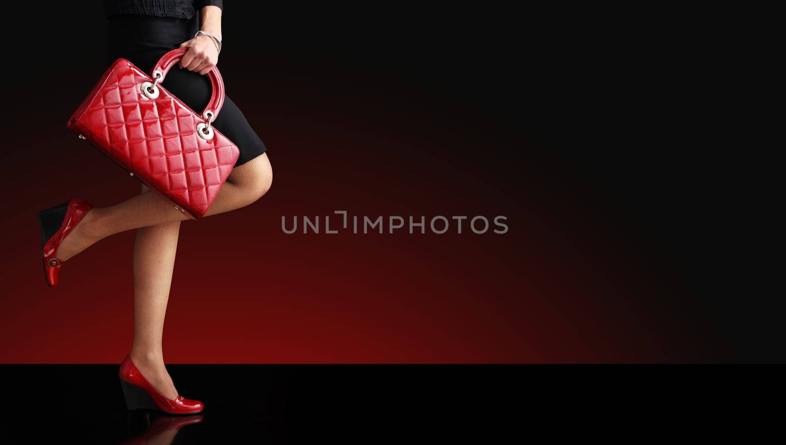 Woman sexy legs with handbag. Shopping and business