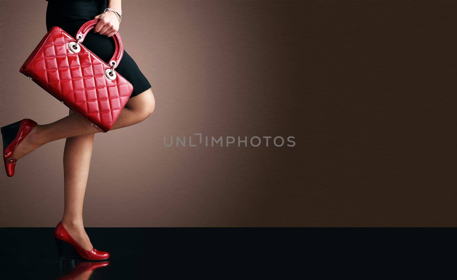 Woman sexy legs with handbag. Shopping and business