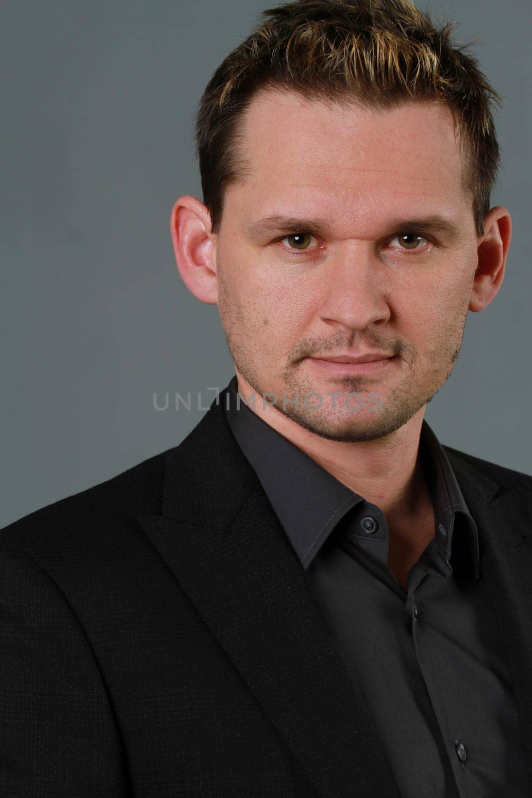 Portrait of business man in studio over grey background