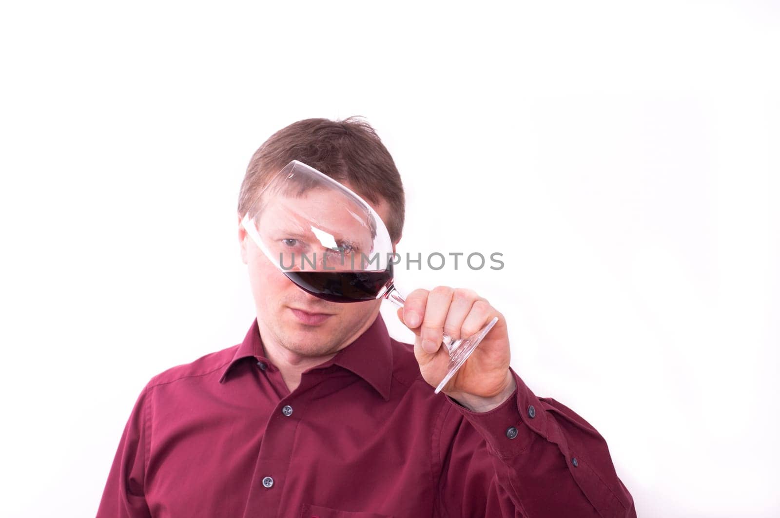 Man visually checks the quality of the wine