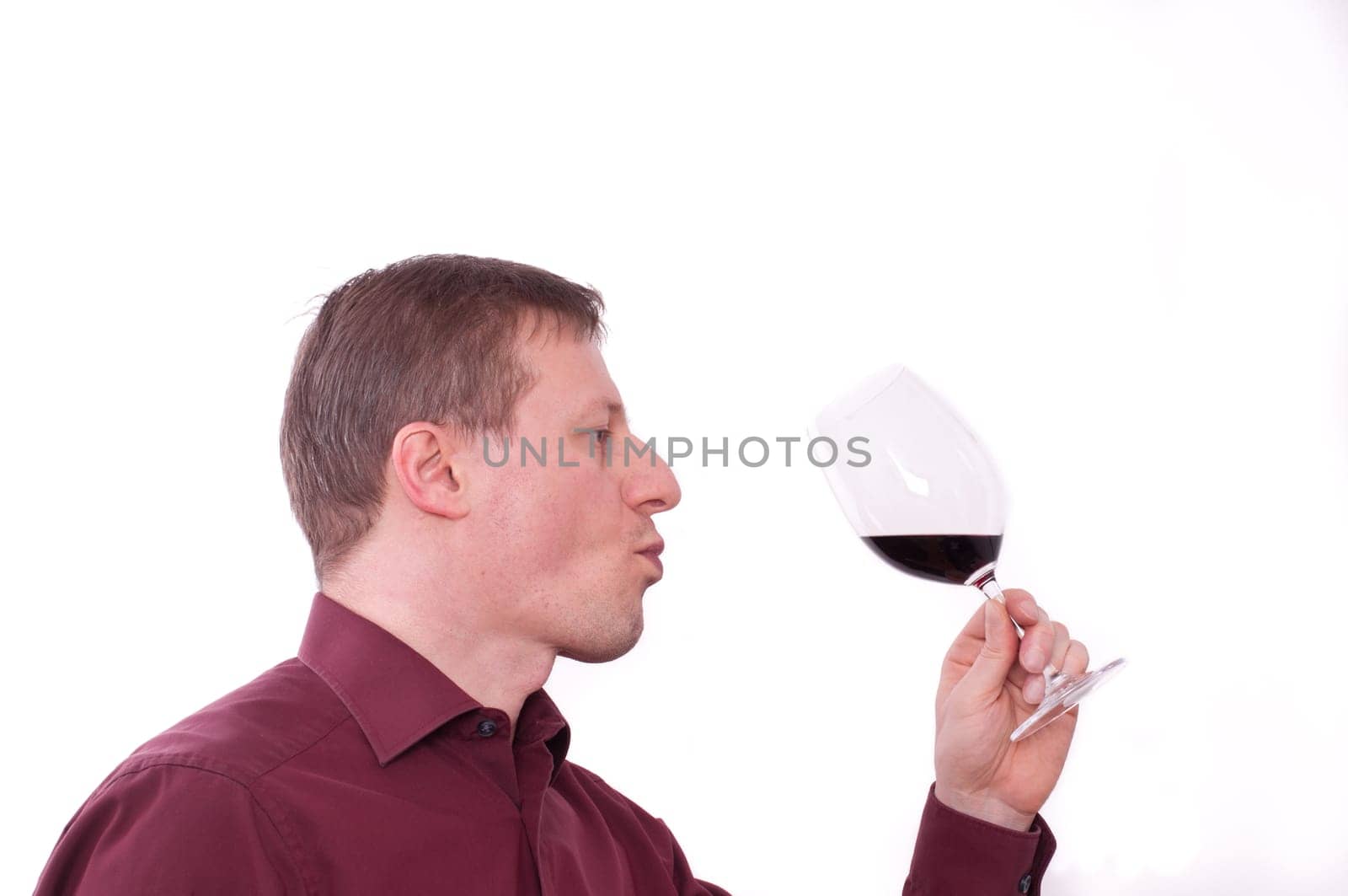A man tastes a red wine