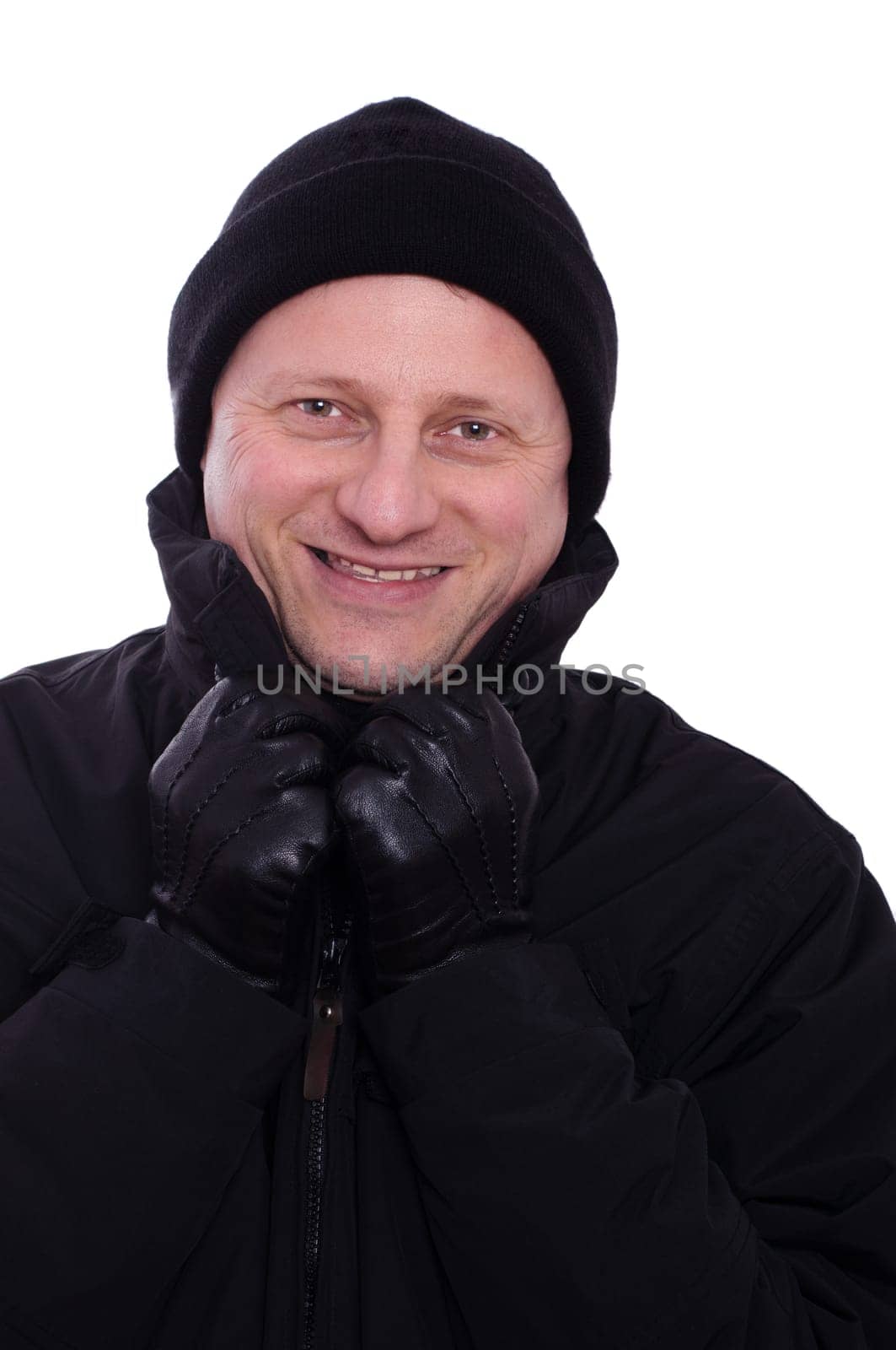 A smiling man with a bobble hat and leather gloves