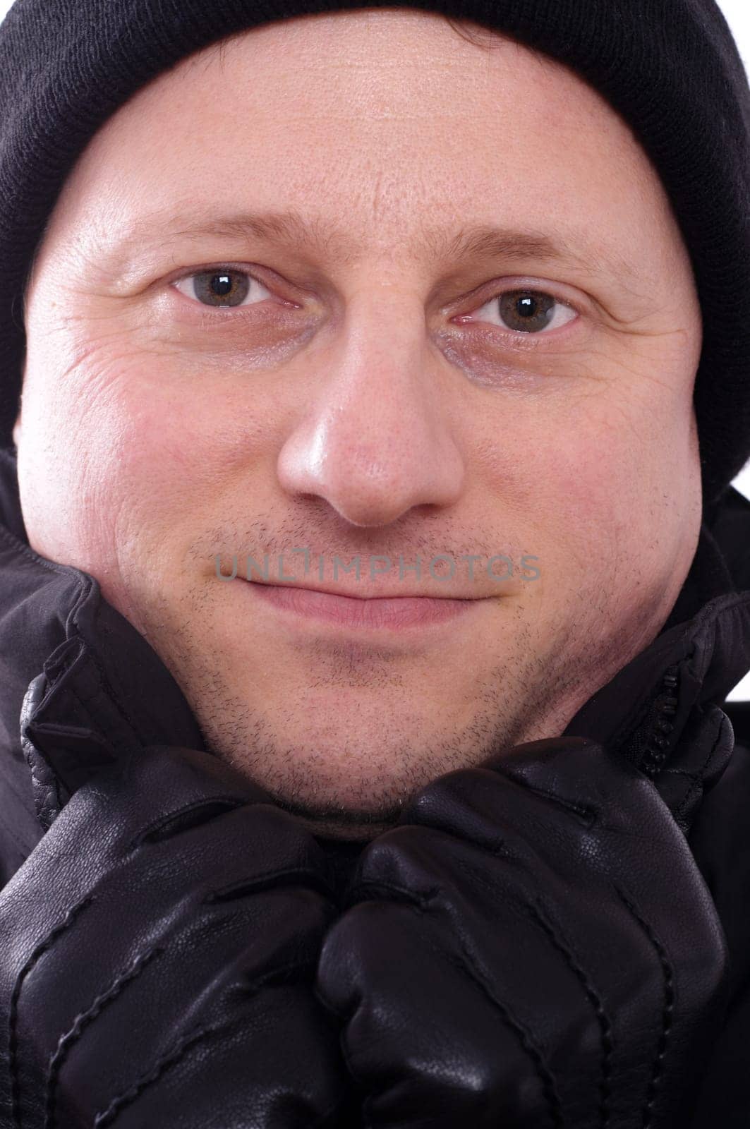 A man with a cap and gloves in the cold