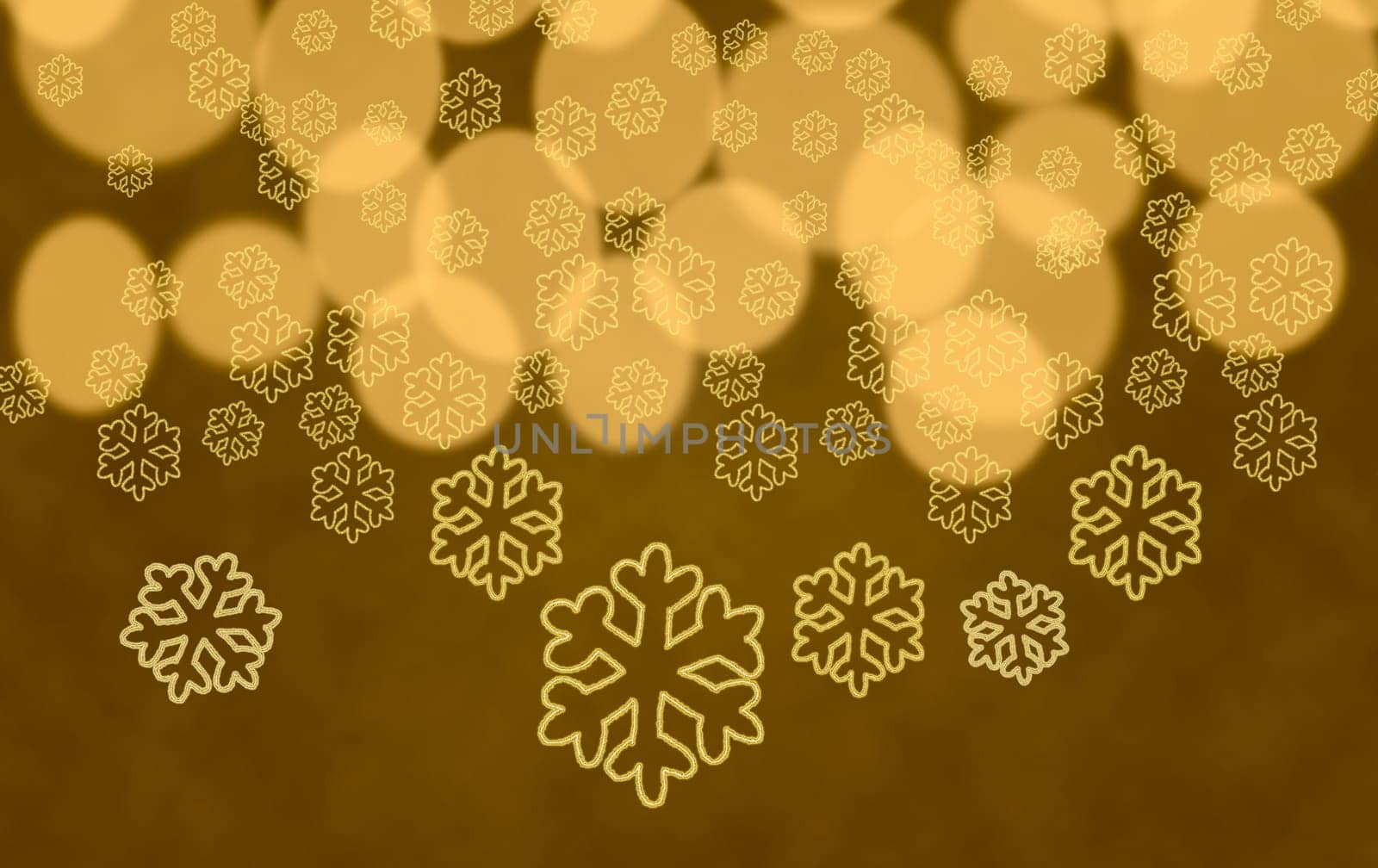 Yellow snowflake shapes dropping in front of golden out of focus christmas tree lights