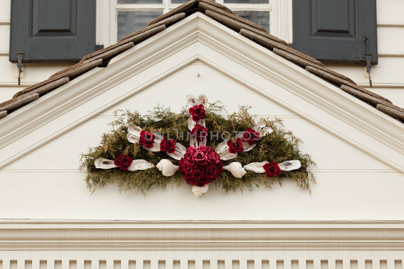Traditional design of a christmas wreath attached to the front of old house