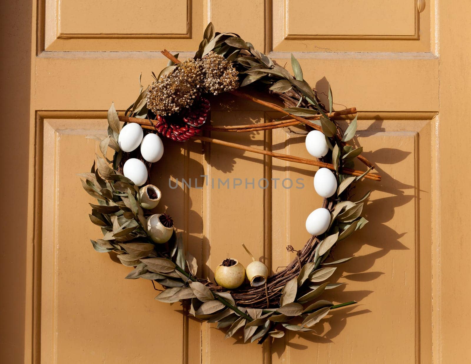 Traditional design of a christmas wreath attached to the front door of old house