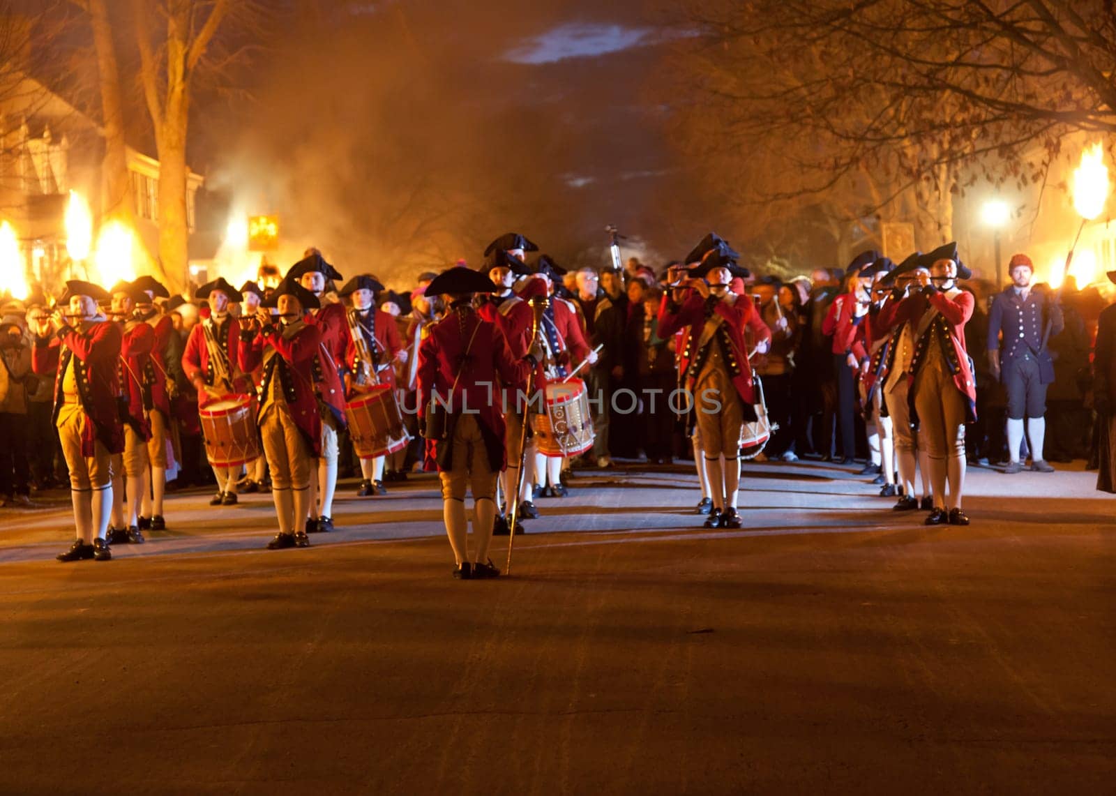 WILLIAMSBURG, VIRGINIA - DECEMBER 29: Marching soldiers at night on December 29, 2011. Colonial Williamsburg&#039 s 301 acres includes many restored buildings and houses and hosts re-enactments.