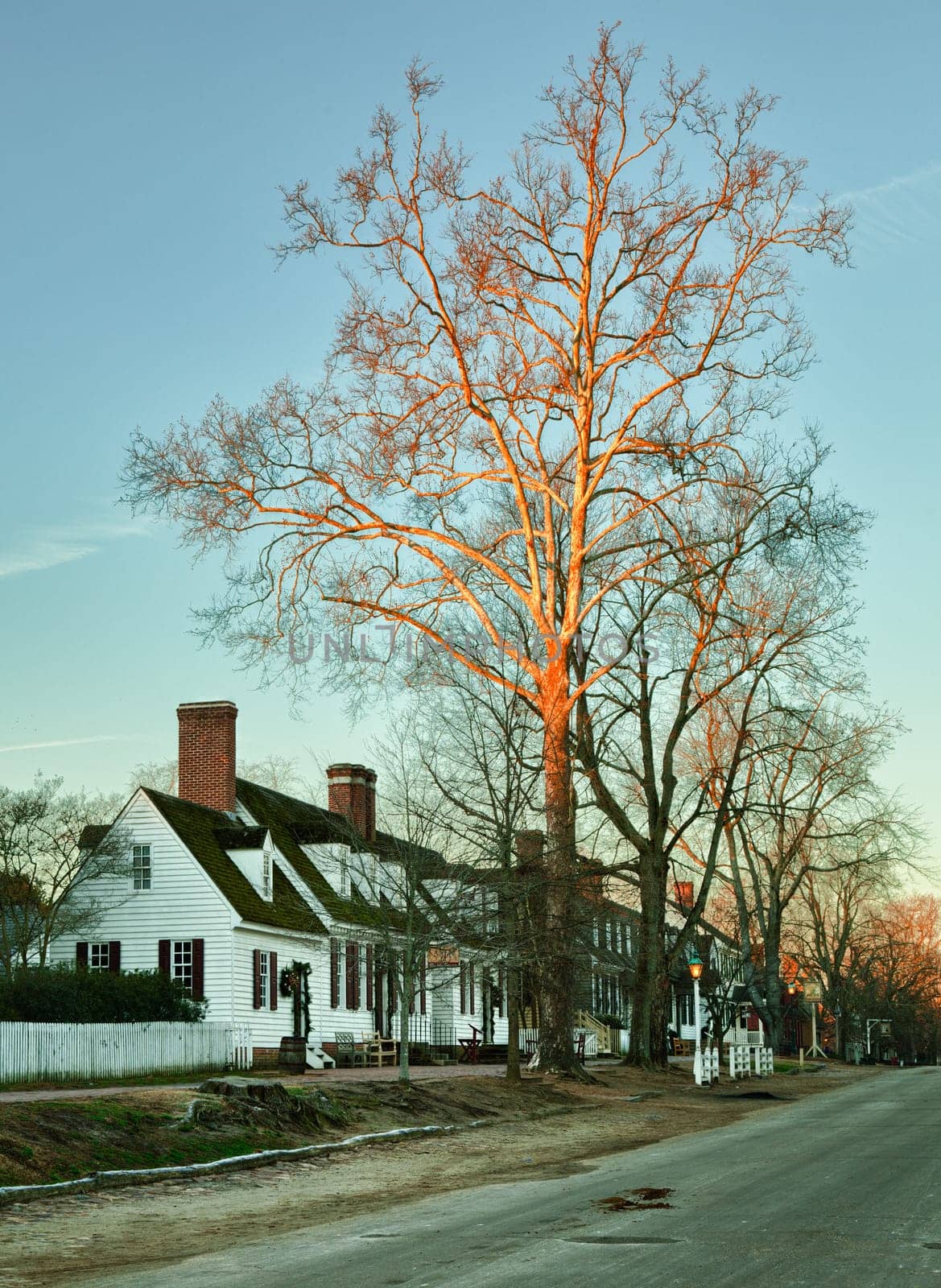 WILLIAMSBURG, VIRGINIA - DECEMBER 30: Sun rises over the restored houses on December 30, 2011. Colonial Williamsburg&#039 s 301 acres includes many restored buildings and houses