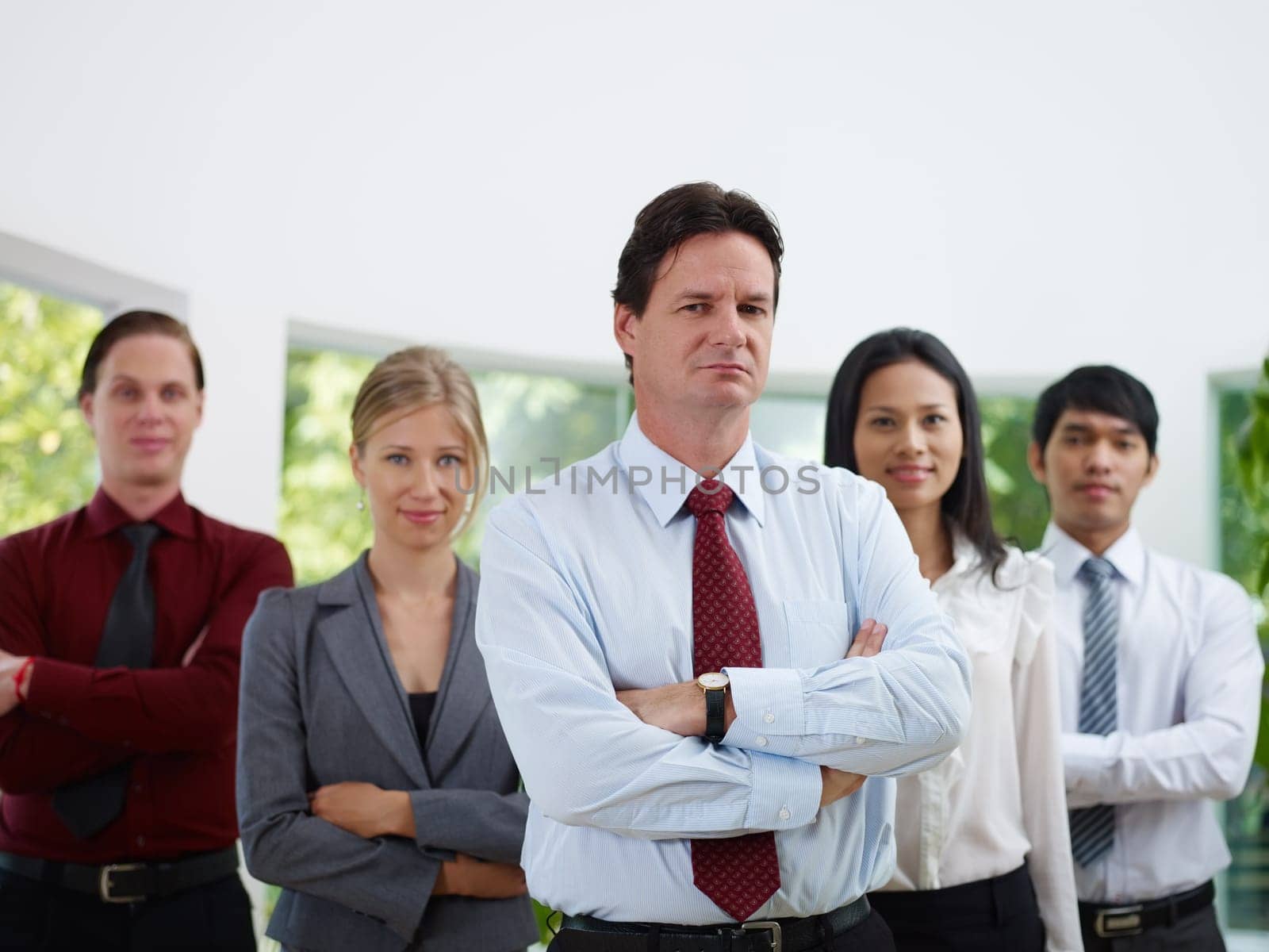 Business team with men and women looking at camera with confidence and pride in office. Copy space, front view
