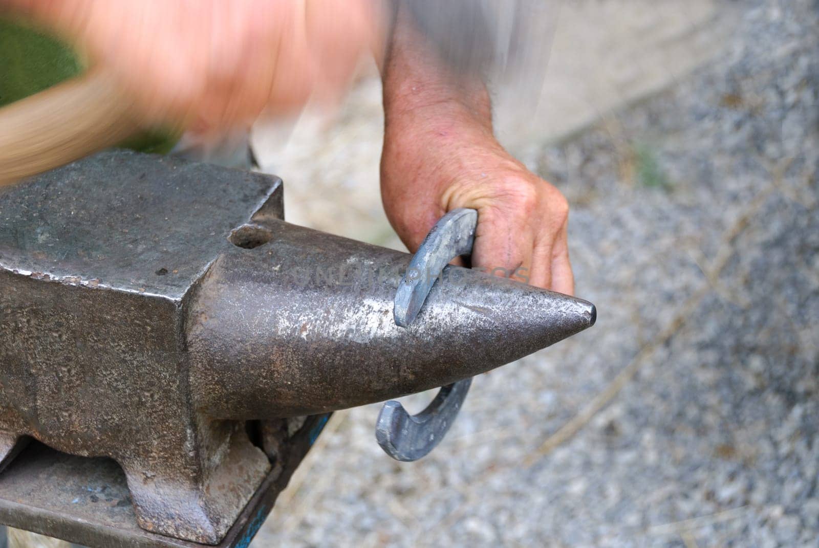 blacksmith while hitting the horseshoe