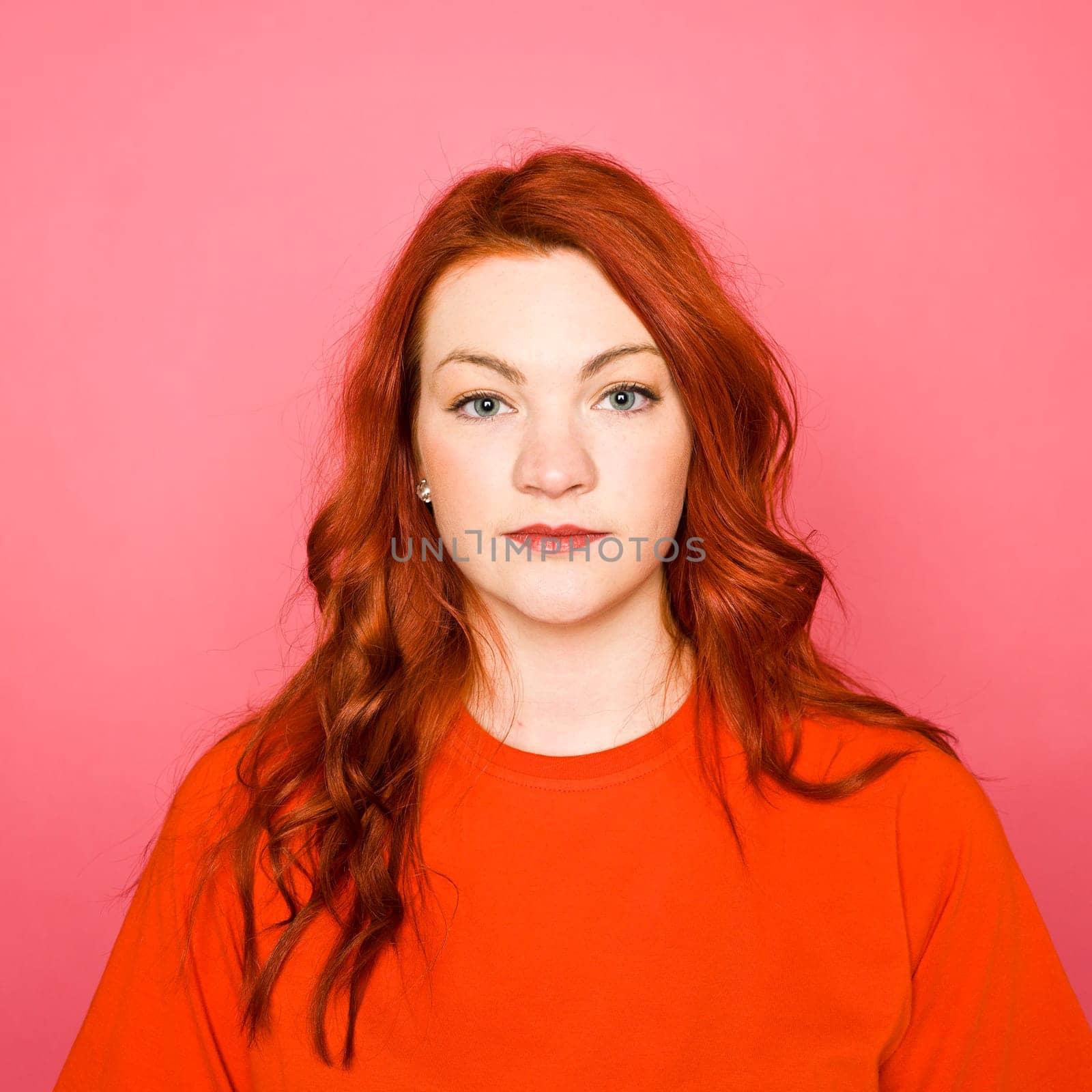 Woman with red hair on pink background